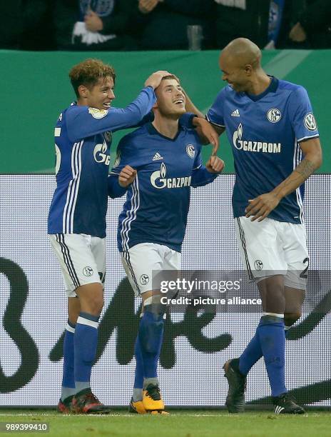 Schalke's Amine Harit , Max Meyer and Naldo celebrate the 1:0 goal by Meyer during the German DFB Cup soccer match between FC Schalke 04 and 1. FC...