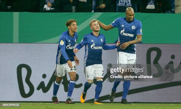 Schalke's Amine Harit , Max Meyer and Naldo celebrate the 1:0 goal by Meyer during the German DFB Cup soccer match between FC Schalke 04 and 1. FC...