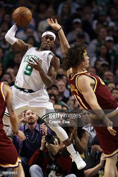Rajon Rondo of the Boston Celtics keeps the ball in bounds as Anderson Varejao of the Cleveland Cavaliers defends during Game Four of the Eastern...
