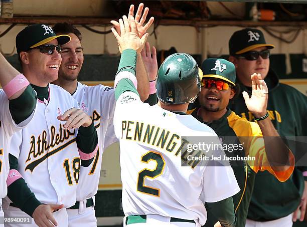 Cliff Pennington of the Oakland Athletics celebrates after scoring on an errant throw by catcher Dioner Navarro of the Tampa Bay Rays in the fourth...