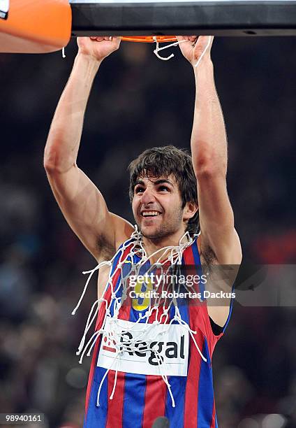 Ricky Rubio of Regal FC Barcelona hangs from the basket while celebrating during the 2009-2010 Euroleague Basketball Champion Awards Ceremony at...