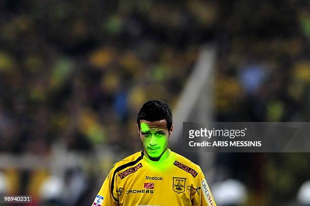 Laser beam lights Aris the face of Thessaloniki's Tony Calvo during the Greek Cup final against Aris Salonica on April 24, 2010 at the Athens Olympic...
