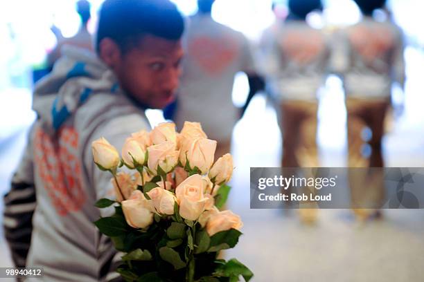 Docker's crew members hand out flowers on Mother's Day during the ''DOCKERS 10,000 Acts of Chivalry'' in Manhattan on May 9, 2010 in New York City.