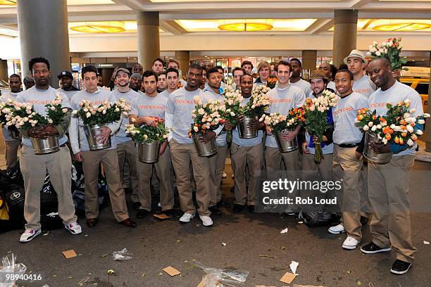 Docker's crew members hand out flowers on Mother's Day during the ''DOCKERS 10,000 Acts of Chivalry'' in Manhattan on May 9, 2010 in New York City.