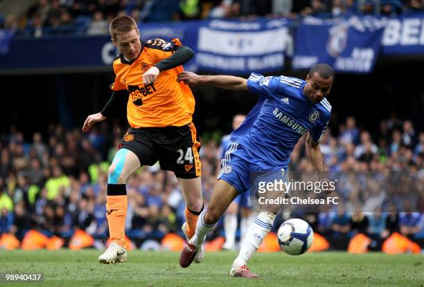 Ashley Cole of Chelsea holds off the challenge from James McCarthy of Wigan during the Barclays Premier League match between Chelsea and Wigan...