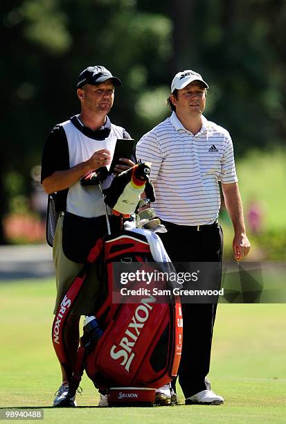 Tim Clark of South Africa waits on the tenth fairway with his caddie Steve Underwood during the final round of THE PLAYERS Championship held at THE...