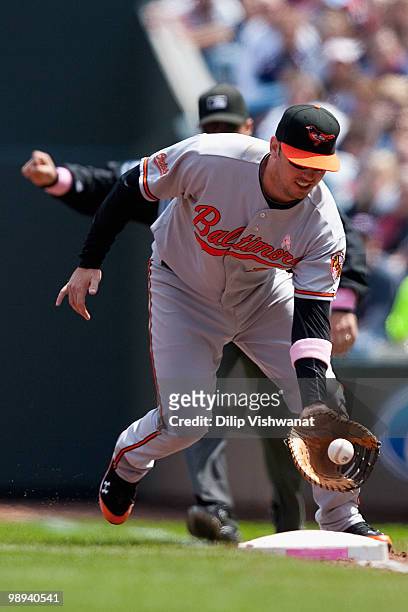 Garrett Atkins of the Baltimore Orioles fields a line drive against the Minnesota Twins at Target Field on May 9, 2010 in Minneapolis, Minnesota. The...