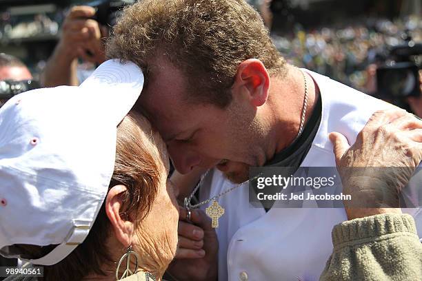 Dallas Braden of the Oakland Athletics celebrates after pitching a perfect game against the Tampa Bay Rays with his grandmother Peggy Lindsey during...