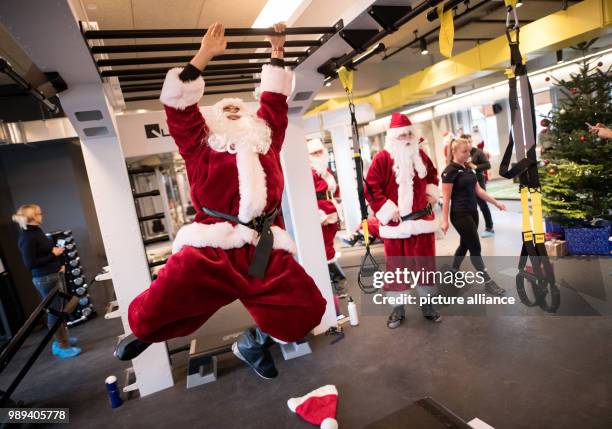 Santa Claus hangs on bars at the fitness centre Meridian in Hamburg, Germany, 20 December 2017. Donations for socially disadvantaged children were...