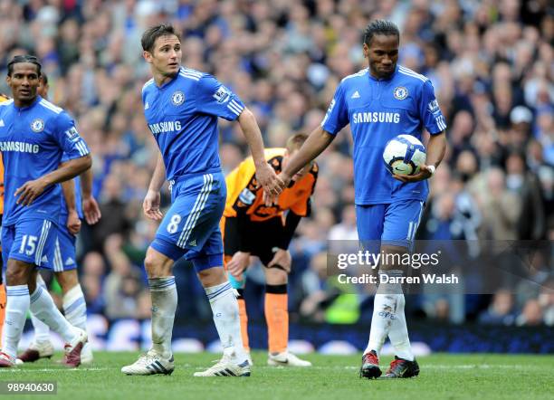 Regular Chelsea penalty taker Frank Lampard hands the ball to teammate Didier Drogba to the penalty kick to score his team's sixth goal during the...