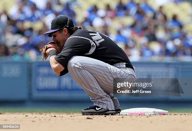 Shortstop Troy Tulowitzki of the Colorado Rockies appears to injure himself after trying to complete a double play in the fifth inning against the...