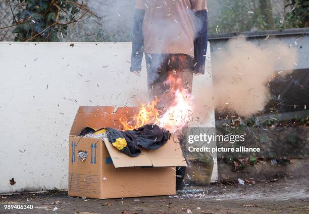 Firework rocket sets a box with clothes on fire during a presentation of the firebrigade on the dangers of wrong usage of fireworks on New Year's Eve...