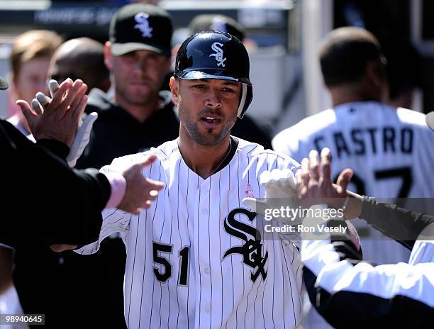 Alex Rios of the Chicago White Sox is greeted by teammates after hitting a home run against the Toronto Blue Jays on May 9, 2010 at U.S. Cellular...