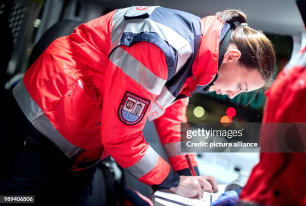 The voluntary helper Jana writes down the demand of blankets and pullovers for homeless and people in need near the main station in Hanover, Germany,...