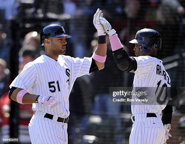 Alex Rios is greeted by Alexei Ramirez of the Chicago White Sox after Rios hit a home run against the Toronto Blue Jays on May 9, 2010 at U.S....
