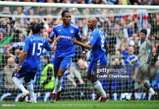 Didier Drogba of Chelsea celebrates with Florent Malouda and Nicolas Anelka as he scores their sixth goal during the Barclays Premier League match...