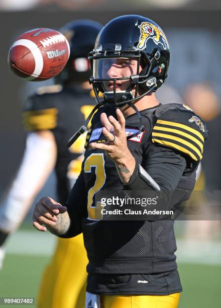 Johnny Manziel of the Hamilton Tiger-Cats warms up prior to action against the Winnipeg Blue Bombers in a CFL game at Tim Hortons Field on June 29,...