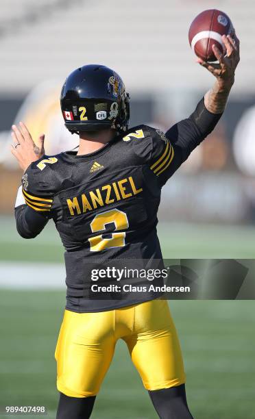 Johnny Manziel of the Hamilton Tiger-Cats warms up prior to action against the Winnipeg Blue Bombers in a CFL game at Tim Hortons Field on June 29,...