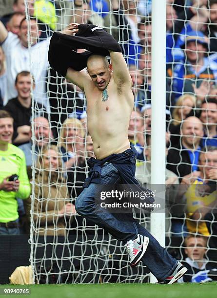 Pitch invader removes his shirt during the Barclays Premier League match between Chelsea and Wigan Athletic at Stamford Bridge on May 9, 2010 in...