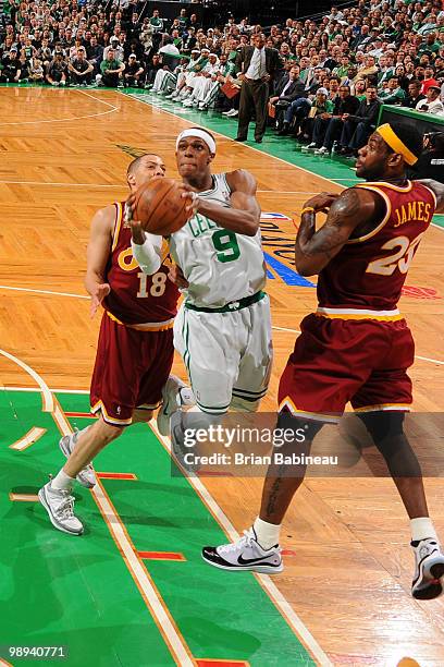 Rajon Rondo of the Boston Celtics lays the ball in the basket against LeBron James of the Cleveland Cavaliers in Game Four of the Eastern Conference...