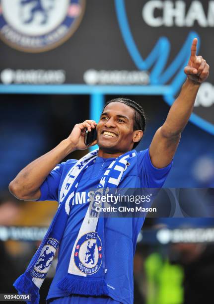 Florent Malouda of Chelsea talks on his mobile phone as he celebrates winning the title after the Barclays Premier League match between Chelsea and...