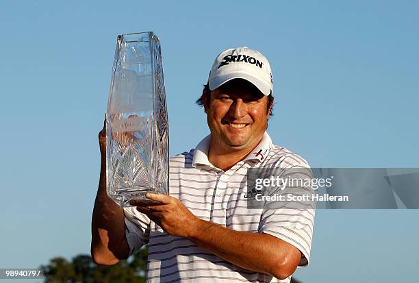 Tim Clark of South Africa smiles while holding the trophy after winning THE PLAYERS Championship held at THE PLAYERS Stadium course at TPC Sawgrass...