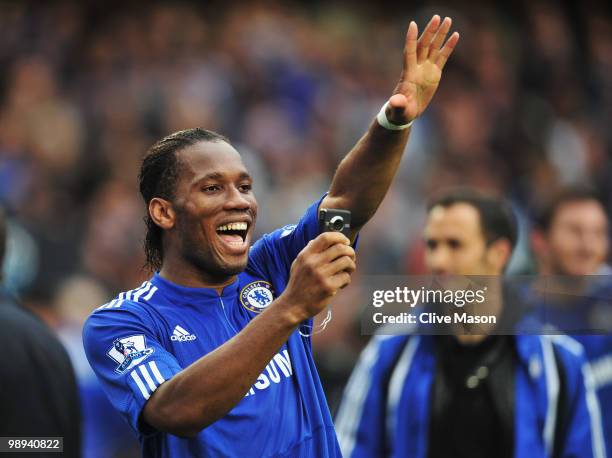 Didier Drogba of Chelsea takes a photograph on his mobile phone as he celebrates winning the title after the Barclays Premier League match between...