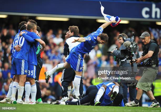 Branislav Ivanovic of Chelsea celebrates with team mates as they win the title after the Barclays Premier League match between Chelsea and Wigan...