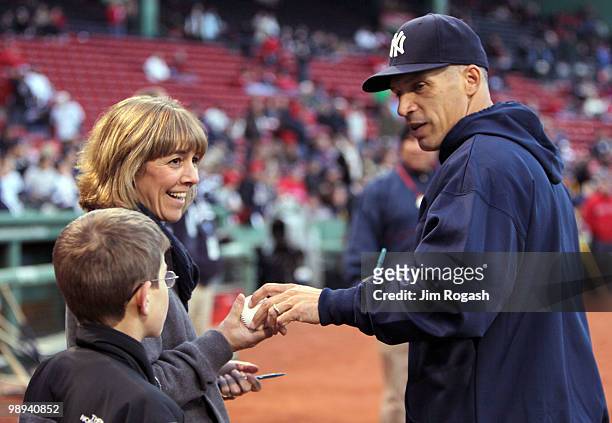 Manager Joe Girardi of the New York Yankees signs an autograph before a game against the Boston Red Sox at Fenway Park on May 9, 2010 in Boston,...