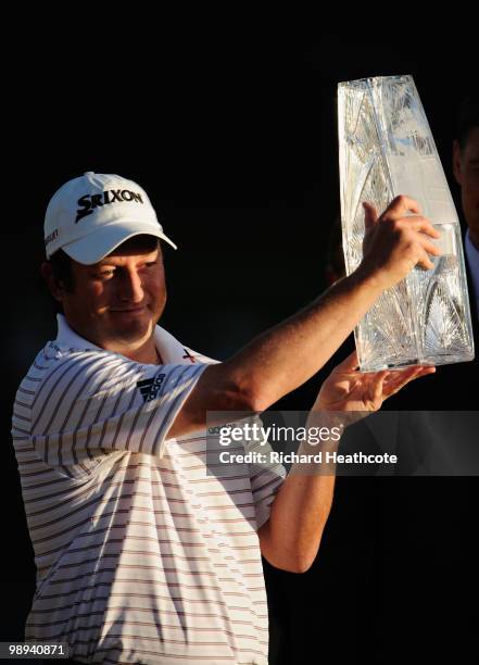 Tim Clark of South Africa smiles while holding the trophy after winning THE PLAYERS Championship held at THE PLAYERS Stadium course at TPC Sawgrass...