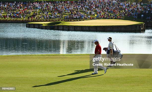 Lee Westwood and caddy Billy Foster walk down the 16th green during the final round of THE PLAYERS Championship held at THE PLAYERS Stadium course at...