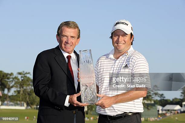 Commissioner Tim Finchem, and Tim Clark hold the winner's trophy after the final round of THE PLAYERS Championship on THE PLAYERS Stadium Course at...