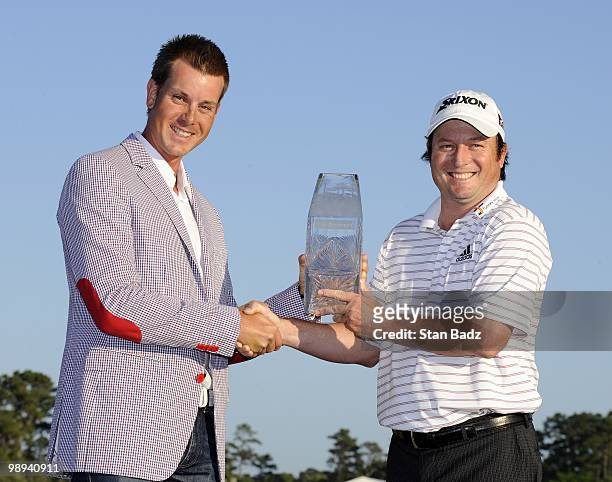 Past Champion Henrik Stenson, presented Tim C lark with the winner's trophy after the final round of THE PLAYERS Championship on THE PLAYERS Stadium...