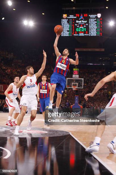 Juan Carlos Navarro, #11 of Regal FC Barcelona competes with Ioannis Bourousis, #9 of Olympiacos Piraeus during the Euroleague Basketball Final Four...