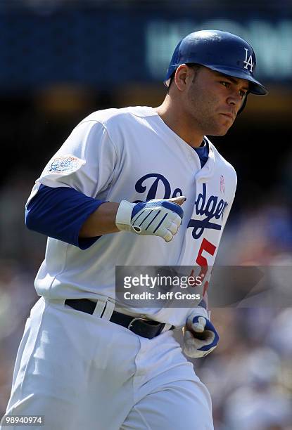 Russell Martin of the Los Angeles Dodgers rounds first base after hitting a solo homerun in the eighth inning against the Colorado Rockies at Dodger...