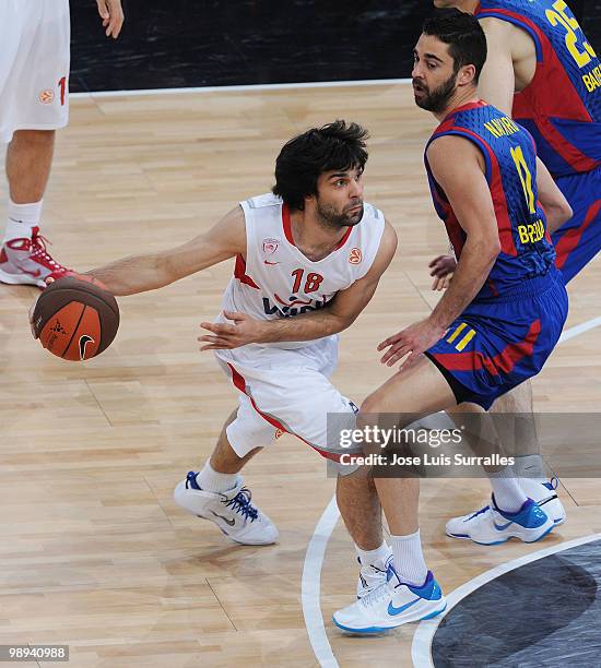 Milos Teodosic, #18 of Olympiacos Piraeus competes with Juan Carlos Navarro, #11 of Regal FC Barcelona during the Euroleague Basketball Final Four...