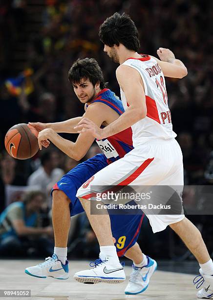 Ricky Rubio, #9 of Regal FC Barcelona competes with Theodoros Papaloukas, #4 of Olympiacos Piraeus in action during the Euroleague Basketball Final...