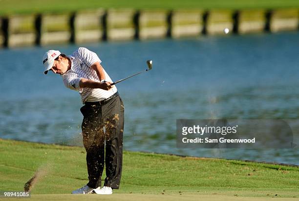 Tim Clark of South Africa plays his approach shot on the 18th hole during the final round of THE PLAYERS Championship held at THE PLAYERS Stadium...