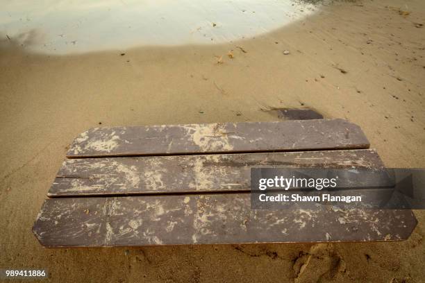 picnic table buried in sand - flanigan stock pictures, royalty-free photos & images