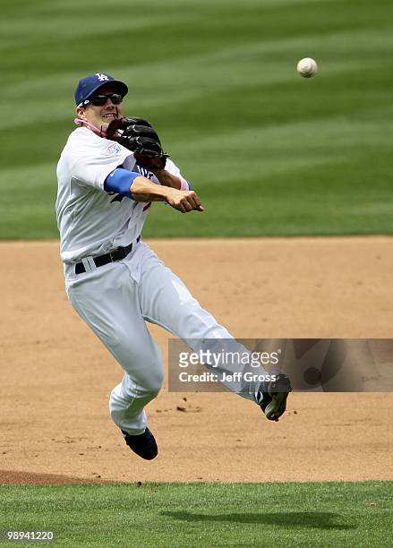 Shortstop Jamey Carroll of the Los Angeles Dodgers throws out Miguel Olivo of the Colorado Rockies in the fourth inning at Dodger Stadium on May 9,...