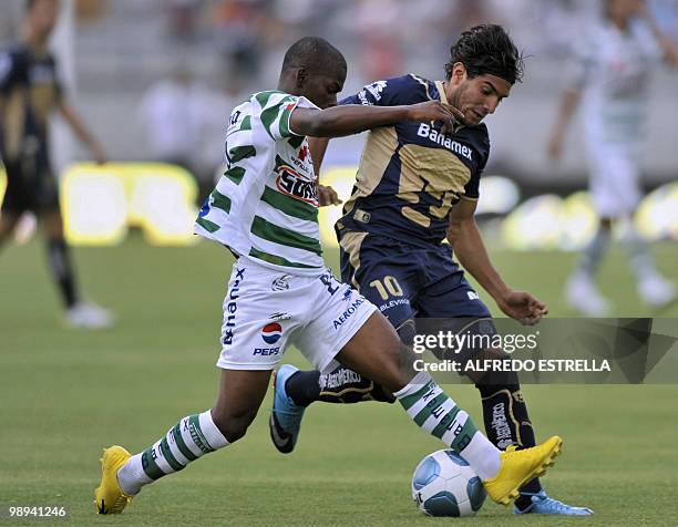 Pumas' Martin Bravo vies for the ball with Santos' Carlos Darwin Quintero , during the second leg of their Mexican Bicentenario Tournament...