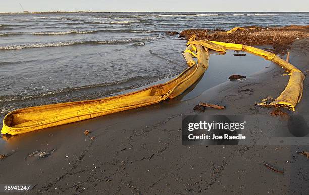 Oil booms are seen washed on to a beach as high winds and waves push the booms ashore on May 9, 2010 in Lafourche Parish, Louisiana. The wellhead of...