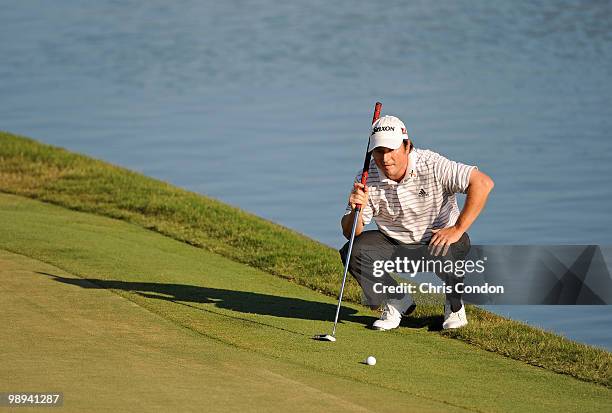 Tim Clark of South Africa lines up a birdie putt at the 18th hole during the final round of THE PLAYERS Championship on THE PLAYERS Stadium Course at...