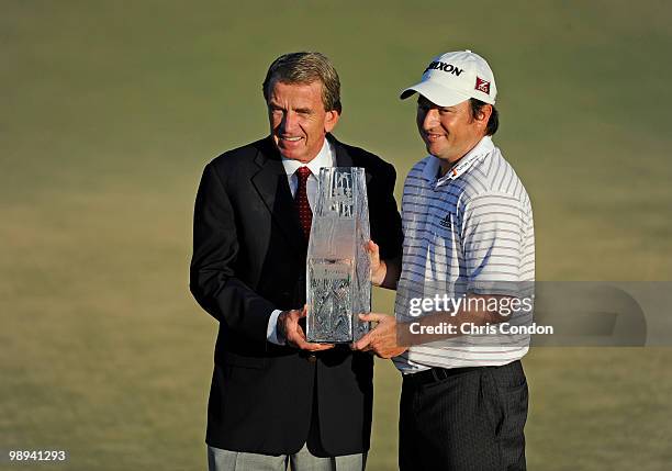 Commissioner Tim Finchem holds the tournament trophy with Tim Clark of South Africa after Clark won THE PLAYERS Championship on THE PLAYERS Stadium...