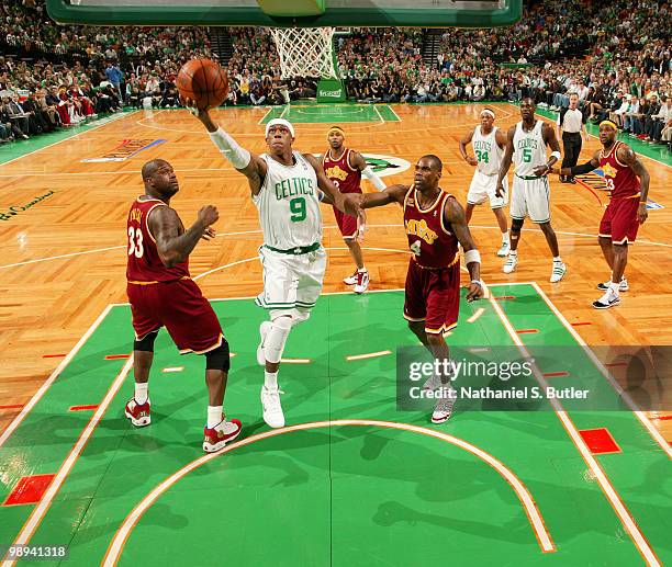 Rajon Rondo of the Boston Celtics shoots against Shaquille O'Neal and Antawn Jamison of the Cleveland Cavaliers in Game Four of the Eastern...
