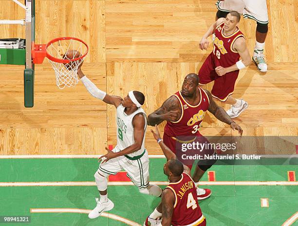 Rajon Rondo of the Boston Celtics shoots against Shaquille O'Neal and Antawn Jamison of the Cleveland Cavaliers in Game Four of the Eastern...