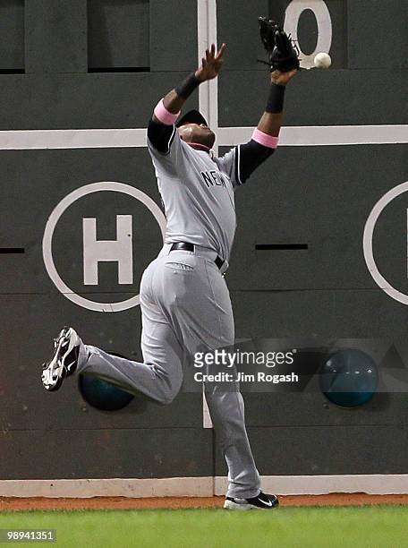 Marcus Thames of the New York Yankees misplays a ball hit by Jeremy Hermida of the Boston Red Sox at Fenway Park on May 9, 2010 in Boston,...