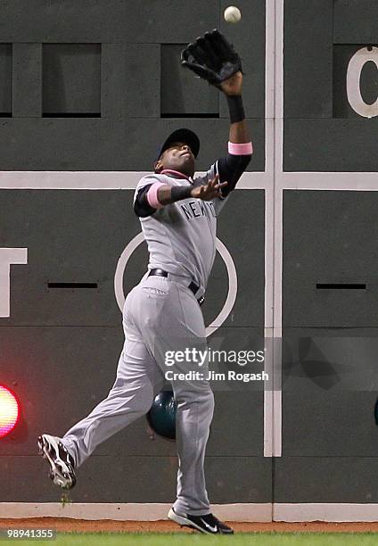 Marcus Thames of the New York Yankees misplays a ball hit by Jeremy Hermida of the Boston Red Sox at Fenway Park on May 9, 2010 in Boston,...