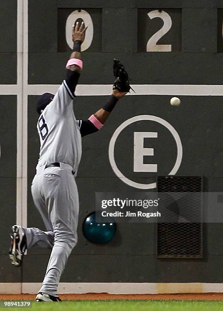 Marcus Thames of the New York Yankees misplays a ball hit by Jeremy Hermida of the Boston Red Sox at Fenway Park on May 9, 2010 in Boston,...