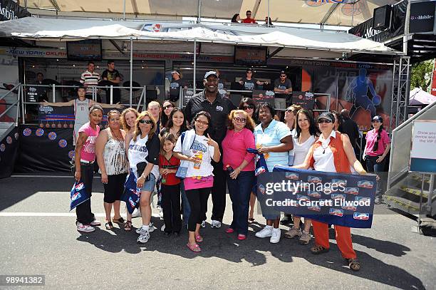 Legend Darryl Dawkins poses for a photo with moms during the NBA Nation Mobile Basketball Tour on May 9, 2010 at the "Cinco De Mayo Festival" in...